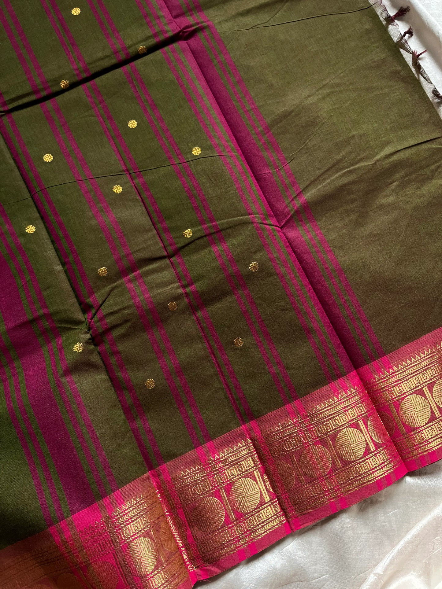 Earthy green Kanchi cotton saree with pink vintage border – handloom drape from House of Thansha.