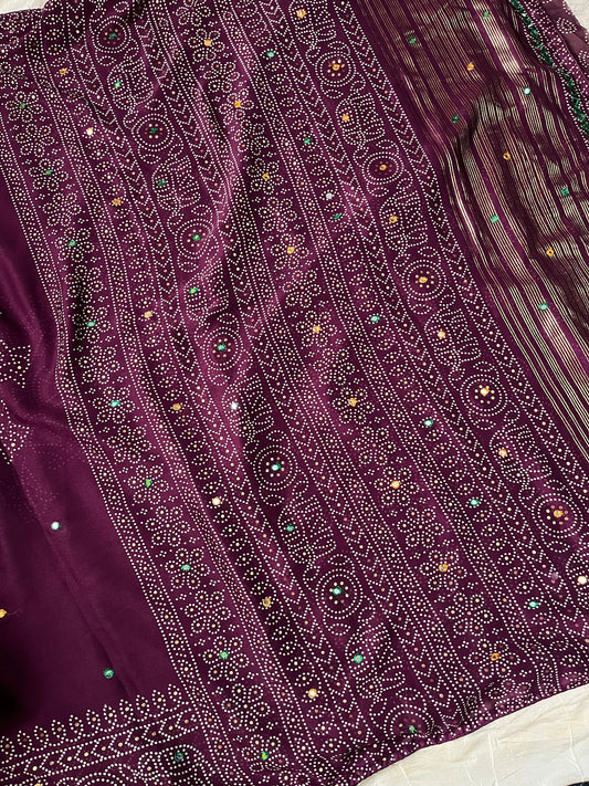 Wine chiffon saree with Bandhani design and all-over mirror work, paired with running blouse