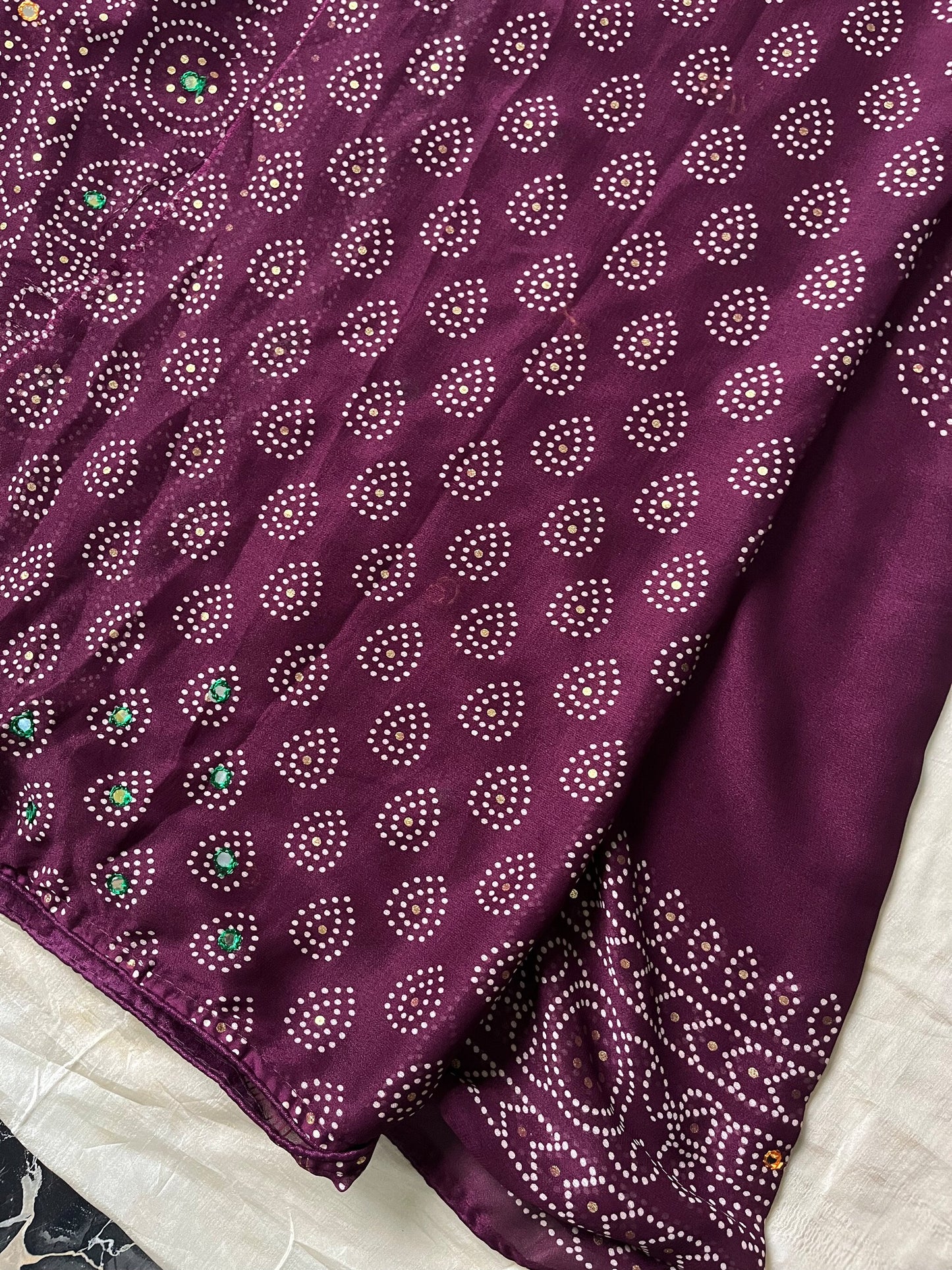 Wine chiffon saree with Bandhani design and all-over mirror work, paired with running blouse