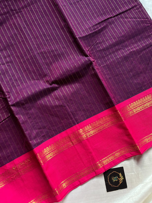 Dark purple Kanchi cotton saree with golden zari stripes and pink border, festive handloom weave.