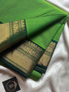 Green saree with gold border on a white background