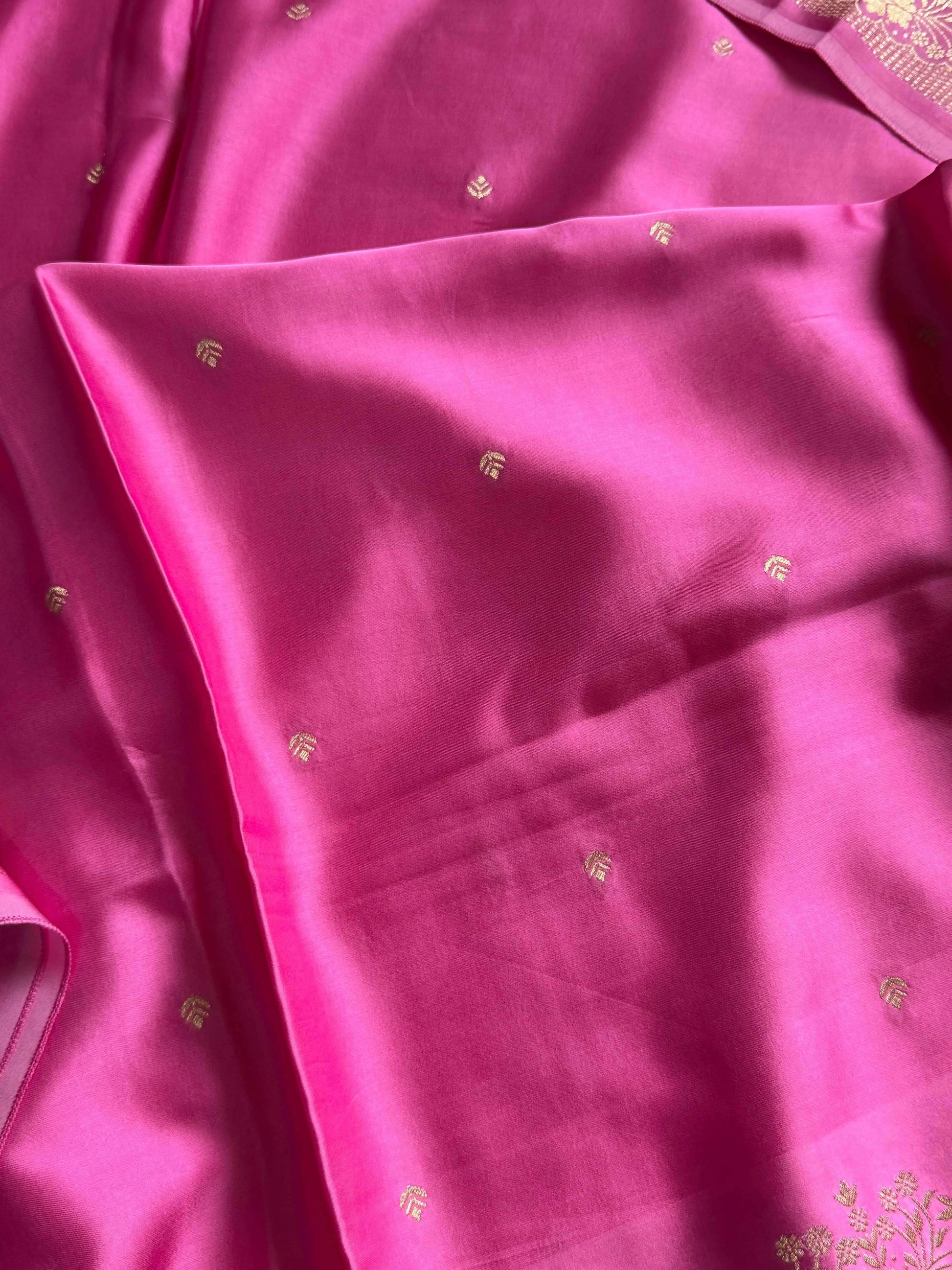 Rose pink Banarasi mashru silk saree with golden zari work and rich pallu.