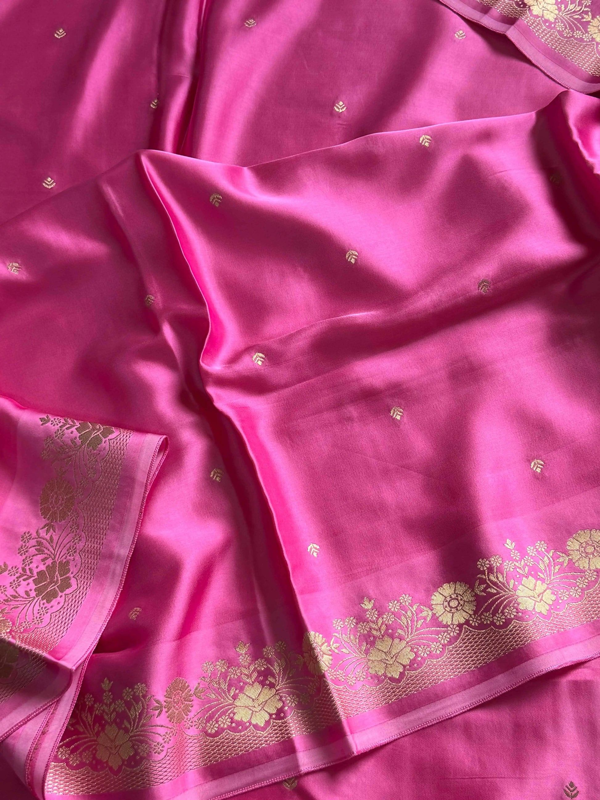Rose pink Banarasi mashru silk saree with golden zari work and rich pallu.