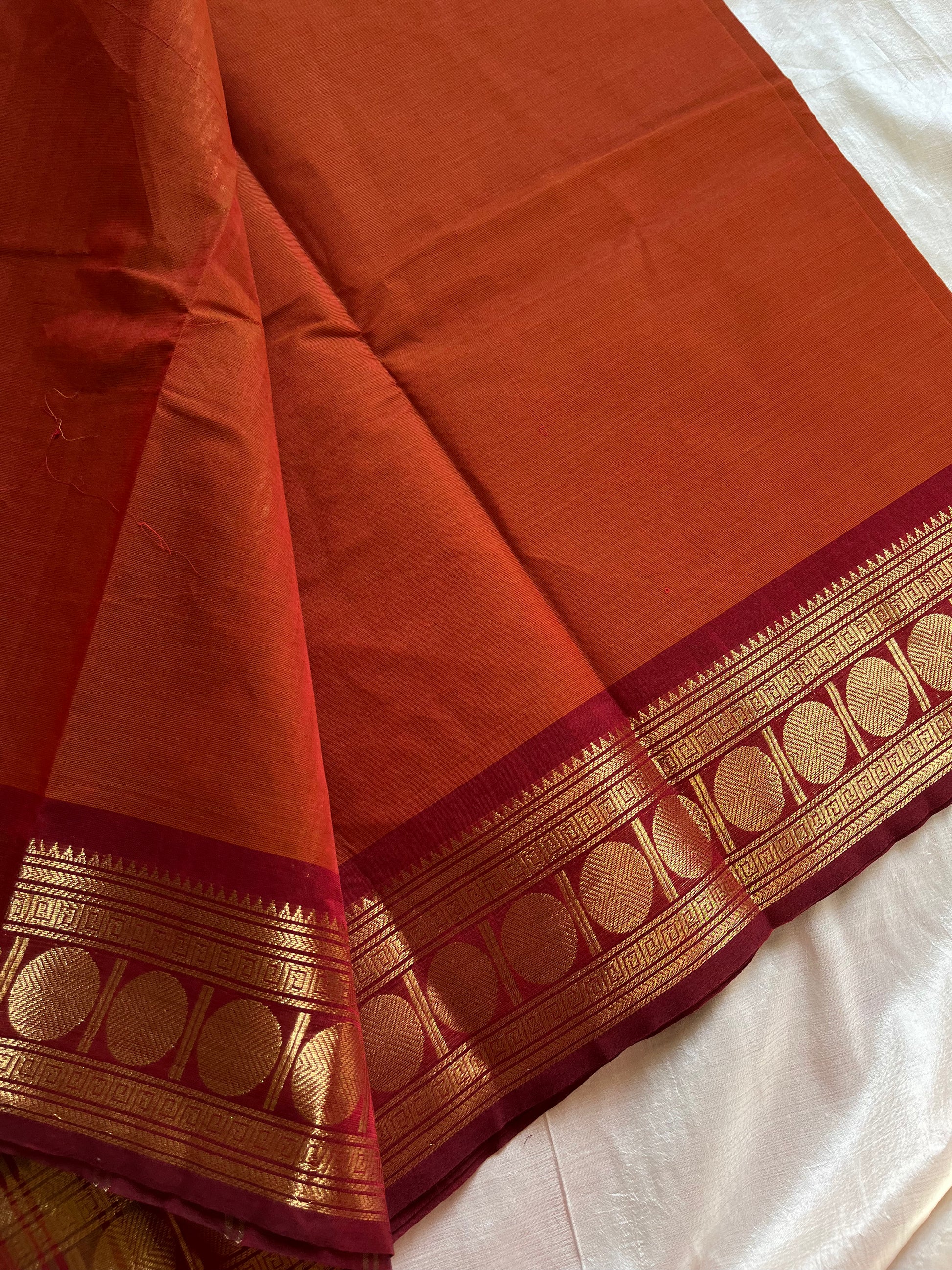 Rust orange Kanchi cotton saree with maroon vintage border – handloom drape from House of Thansha.
