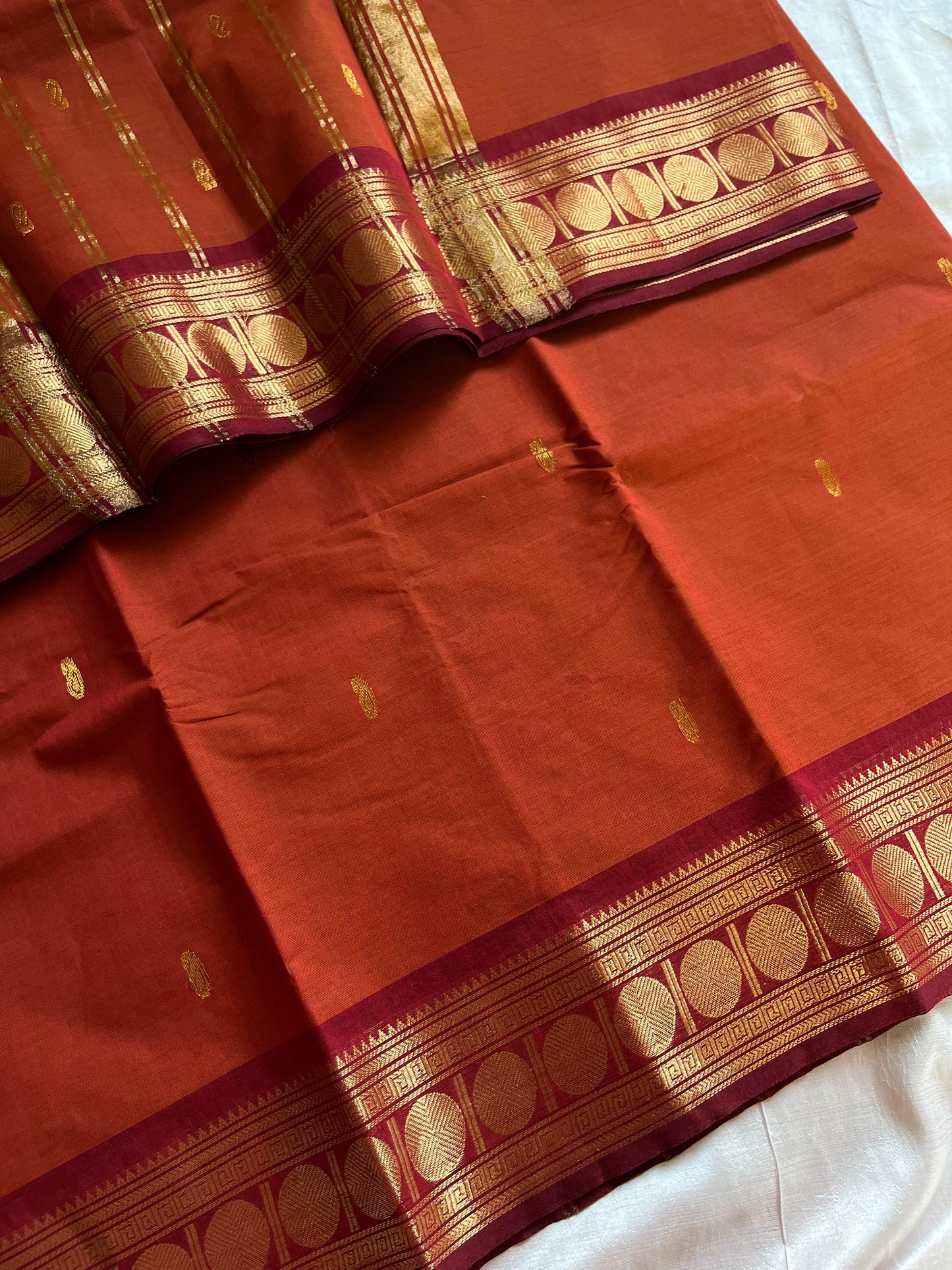 Rust orange Kanchi cotton saree with maroon vintage border – handloom drape from House of Thansha.