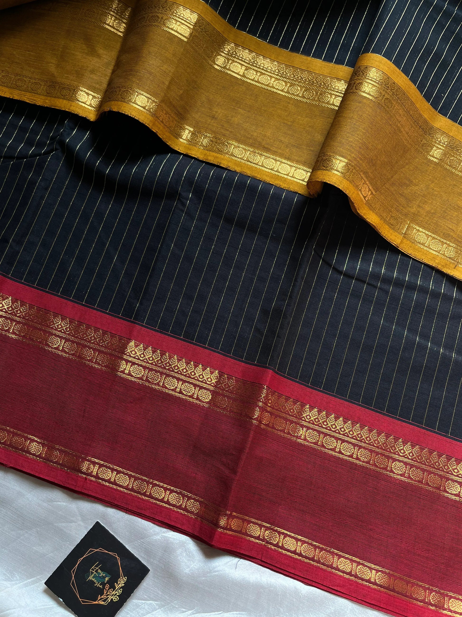 Zari Edition Black Kanchi Cotton Saree with golden zari stripes and dual Ganga Jamuna border in maroon and mustard yellow – House of Thansha