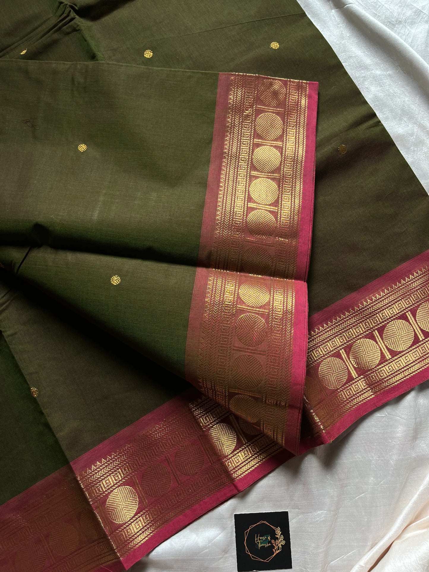 Earthy green Kanchi cotton saree with pink vintage border – handloom drape from House of Thansha.
