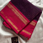 Dark purple Kanchi cotton saree with golden zari stripes and  pink border, festive handloom weave.