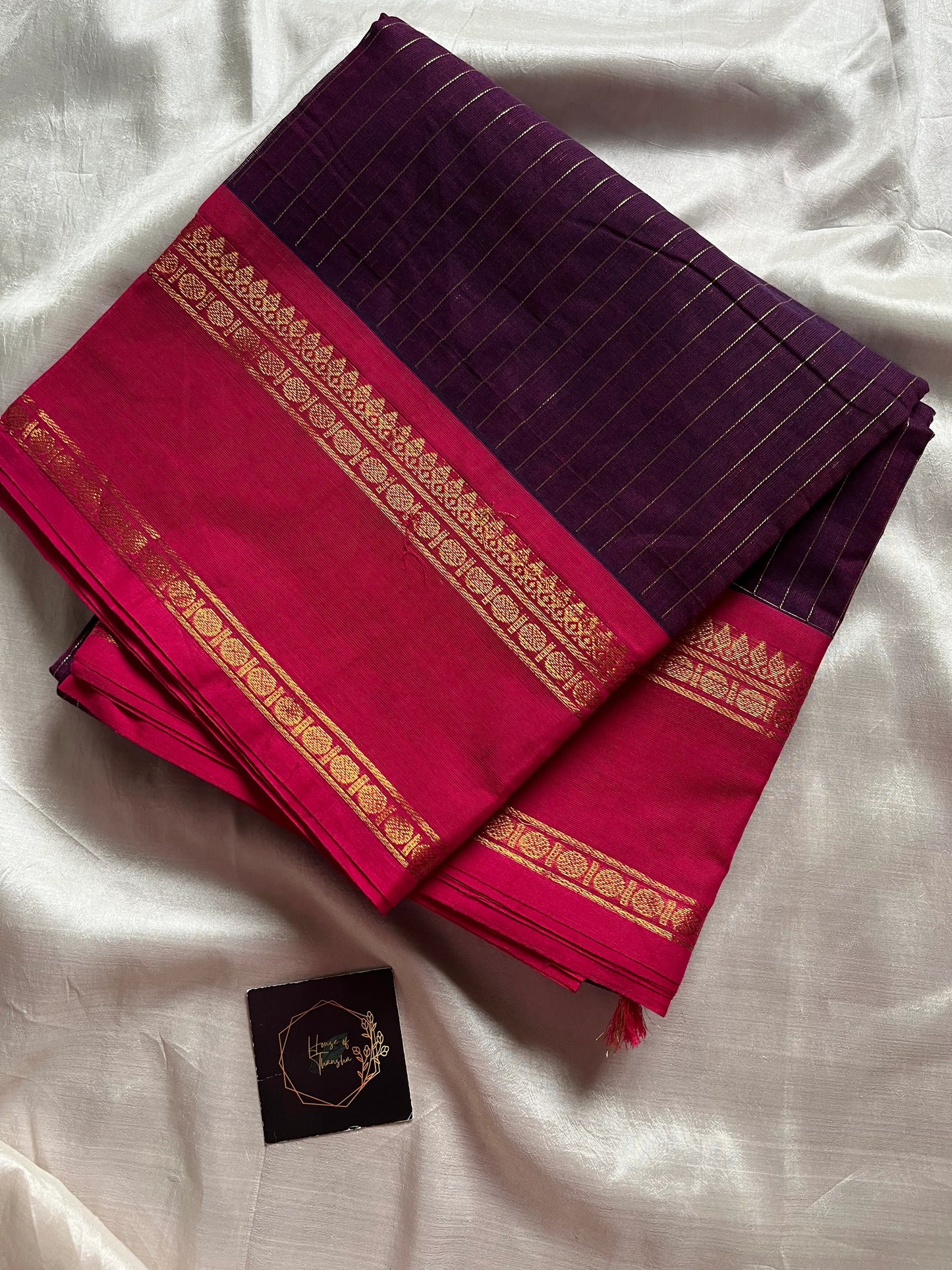 Dark purple Kanchi cotton saree with golden zari stripes and  pink border, festive handloom weave.