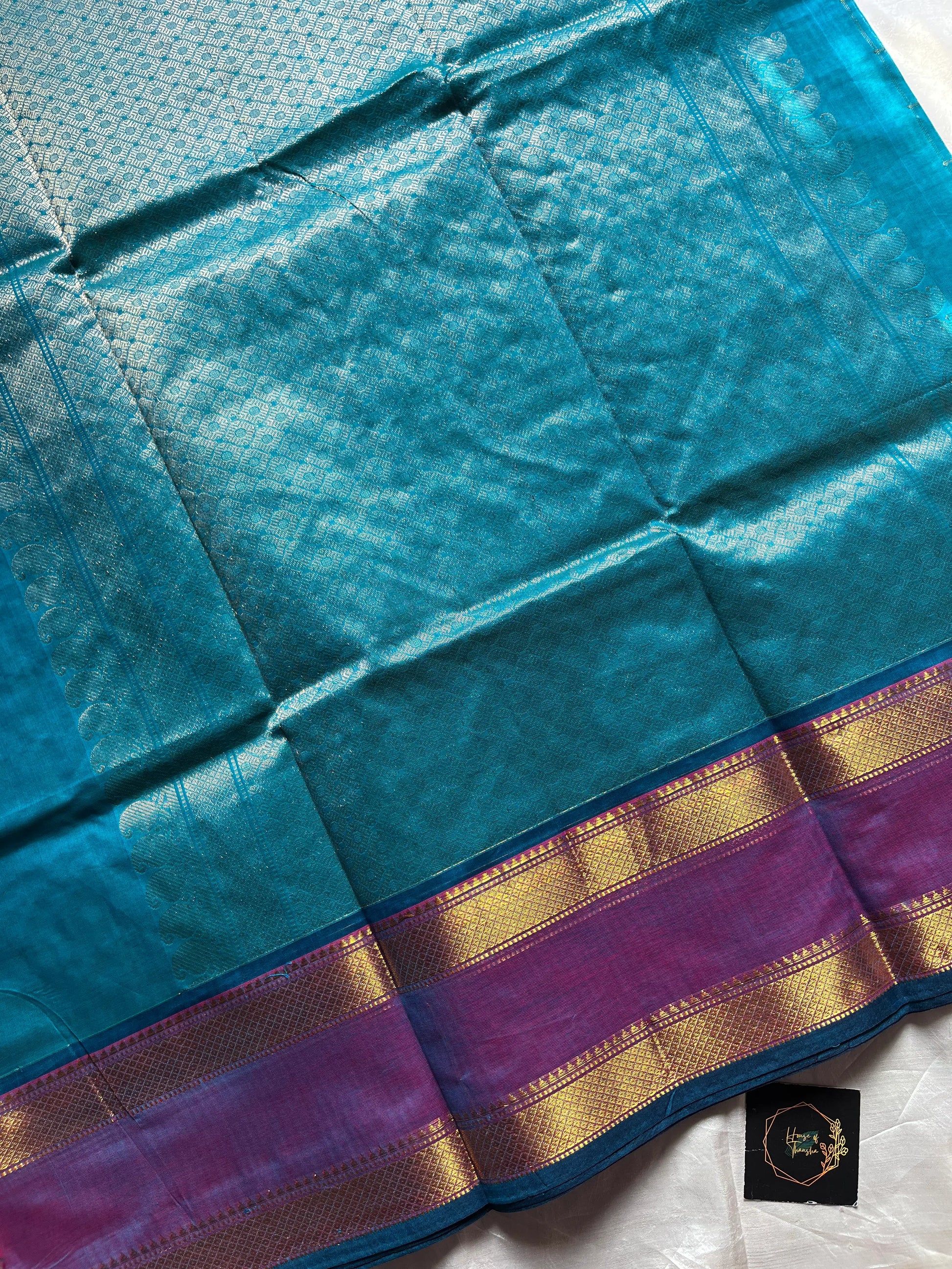 Blue pure Kanchi cotton saree featuring golden zari checks and a grand zari pallu.