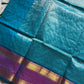Blue pure Kanchi cotton saree featuring golden zari checks and a grand zari pallu.