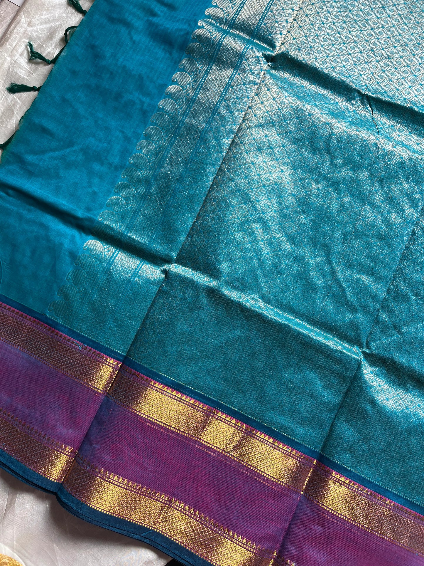 Blue pure Kanchi cotton saree featuring golden zari checks and a grand zari pallu.
