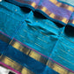 Blue pure Kanchi cotton saree featuring golden zari checks and a grand zari pallu.