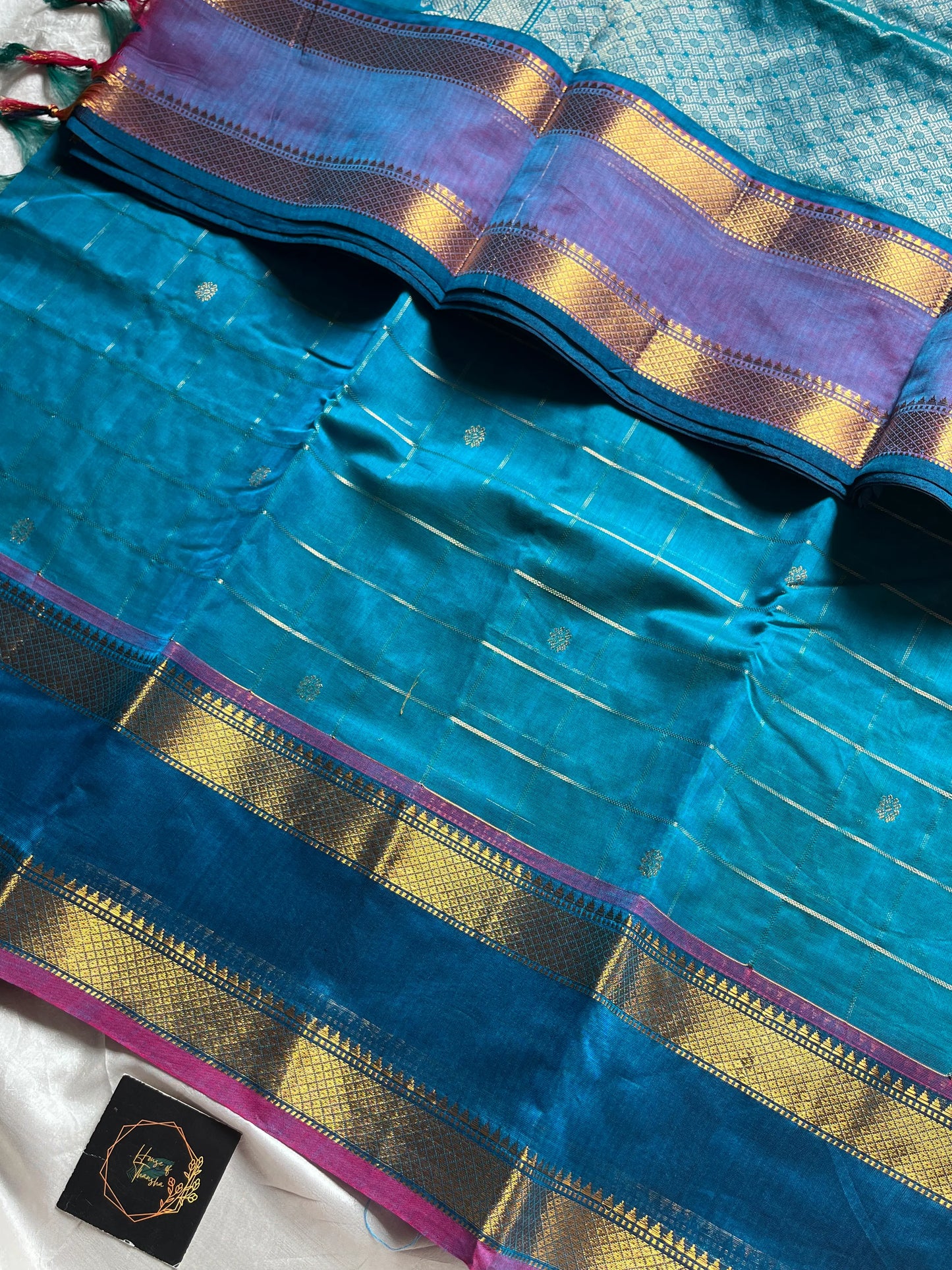 Blue pure Kanchi cotton saree featuring golden zari checks and a grand zari pallu.