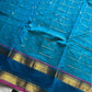 Blue pure Kanchi cotton saree featuring golden zari checks and a grand zari pallu.