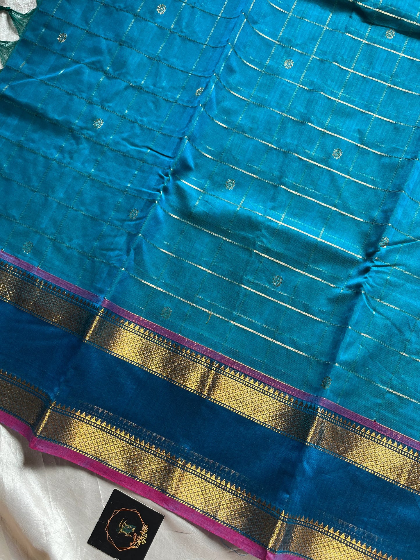 Blue pure Kanchi cotton saree featuring golden zari checks and a grand zari pallu.