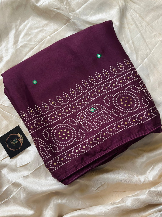 Wine chiffon saree with Bandhani design and all-over mirror work, paired with running blouse