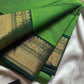 Green saree with gold border on a white background