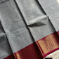 Grey Chettinadu cotton saree with subtle weave and pink border